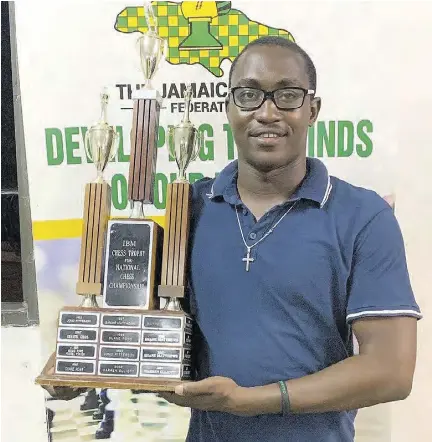 FM Shreyas Smith holding a championship trophy